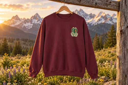 Holiday Gift Sweatshirt - Maroon on a wooden hanger outdoors | MR7ART