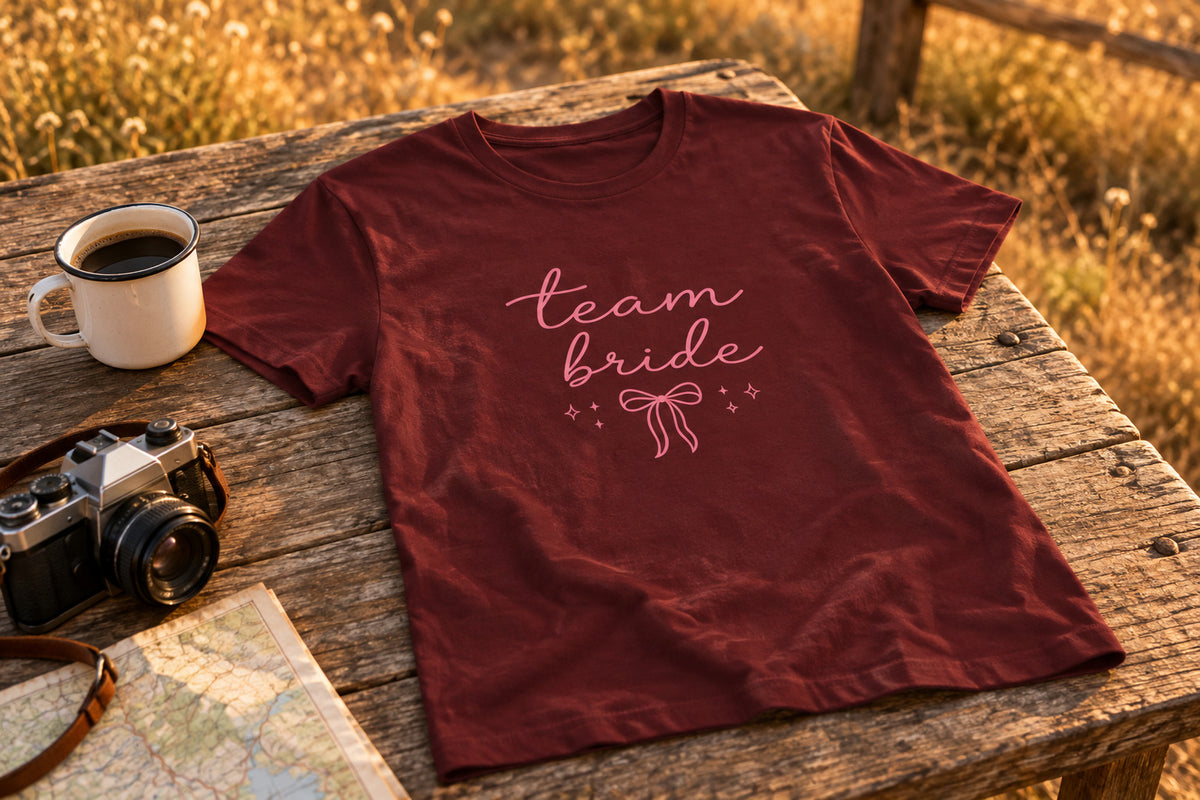 Team Bride tee - Maroon on a rustic wooden table | MR7ART